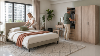 Practical Singapore bedroom with a beige upholstered bed and light oak wardrobe for downsizing in retirement.