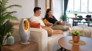 Bladeless fan on a side table in a modern Singapore living room with a couple relaxing on the sofa