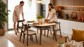 Bohemian dining table set in a warm modern Singapore home styled with woven accents, plants, and natural wood decor