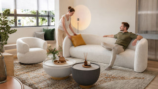 White bouclé sofa and matching armchair in a bright Singapore living room styled for everyday comfort.