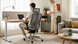 Grey mesh ergonomic office chair in a bright Singapore home office with a compact work desk and modern living room setting.