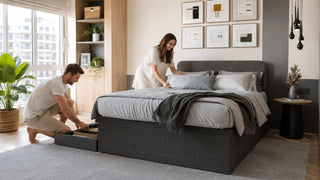 Charcoal upholstered storage bed in a modern Singapore bedroom with organised under-bed storage for practical built-in bed planning.