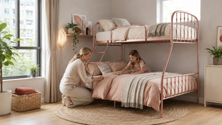 Rose-gold bunk bed in a bright Singapore bedroom with a parent and child arranging bedding for a practical family room setup