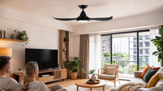 Black ceiling fan with light in a bright modern Singapore living room with warm wood furniture and balcony daylight