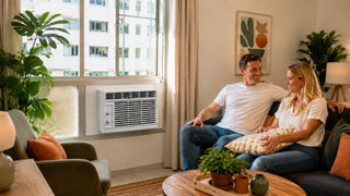White window air conditioner in a bright modern Singapore living room with a couple relaxing on the sofa