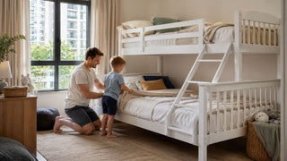 White children’s bunk bed in a modern Singapore bedroom with a parent helping a child arrange the bedding