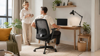 Black mesh comfort design office chair in a modern Singapore home office corner with a couple working from home