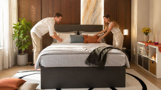 Modern storage bed in a Singapore bedroom prepared for Deepavali guests with warm neutral bedding and terracotta accents