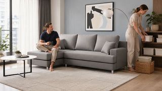 Grey L-shaped sofa in a modern Singapore living room with organised airtight storage containers beside the shelving unit