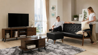Modern HDB living room with black tufted sofa, matching ottoman, wood TV console, and coffee table for a practical MegaFurniture home design guide