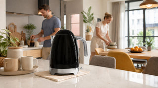 Glossy black electric kettle on a kitchen counter in a bright modern Singapore home, styled for everyday hot drink preparation.
