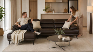 Dark brown L-shaped sofa in a compact Singapore condo living room with a practical open-plan layout
