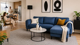 Blue L-shaped sofa in a modern Singapore condo living room with open dining layout and practical walking space