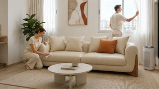 Cream leather sofa in a bright Singapore living room as homeowners air out the space and wipe the sofa for mould prevention.