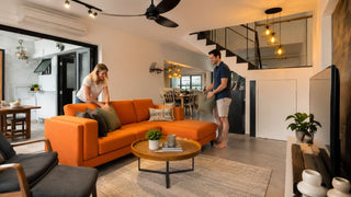Orange L-shaped sofa in a modern Singapore maisonette living room with clear walking space and practical family layout.
