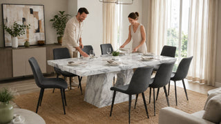 Marble dining table set in a bright modern Singapore home with a couple preparing the dining area