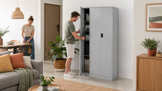 Light grey metal storage cabinet in a modern Singapore living room with a couple organising household items
