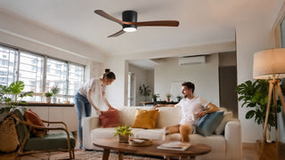 Modern ceiling fan with wooden blades in a bright Singapore HDB living room with a relaxed family setting