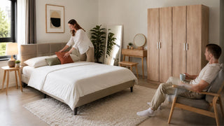 Modern bedroom set with an upholstered bed, wood wardrobe, and vanity in a bright Singapore condo bedroom.