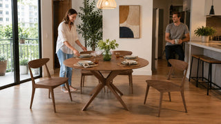 Modern wooden dining table set in a bright Singapore condo dining area with a couple preparing the table