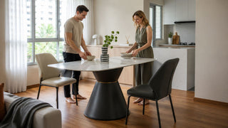 Modern marble dining table in a bright Singapore home with a couple setting the table for everyday dining