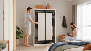 Modular wardrobe in a modern Singapore bedroom with a couple organising clothes and storage for everyday home use