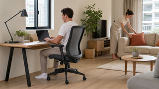 Modern office chair in a compact Singapore home office beside a living room setup