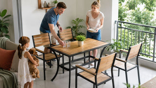 Outdoor dining set with four wooden chairs on a bright Singapore condo balcony for relaxed family use.