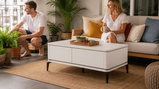 White outdoor coffee table on a sheltered Singapore balcony with a relaxed seating area and potted plants.