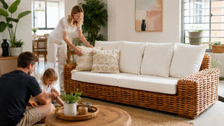 Rattan sofa with white cushions in a bright Singapore living room styled for relaxed family comfort.