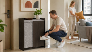 Dark wood shoe cabinet with cushioned top in a modern Singapore executive flat entryway with practical storage space.