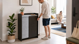 Compact shoe cabinet in a modern Singapore condo entryway with residents organising shoes near the living room.