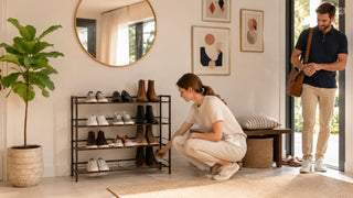 Dark metal shoe rack in a modern Singapore entryway with a couple organising shoes before heading out