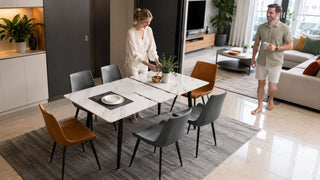 White sintered stone dining table in a modern Singapore home with a couple preparing the dining area
