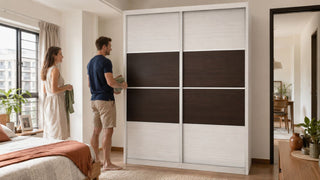 Sliding wardrobe in a bright modern Singapore bedroom with a couple organising clothes for a tidy home layout