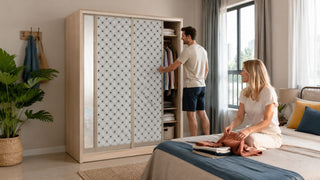 Sliding wardrobe in a modern Singapore bedroom with a couple organising clothes in a bright, practical home setting