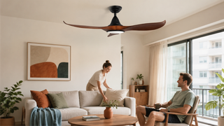 Small ceiling fan with light in a bright Singapore condo living room with compact seating and warm modern decor