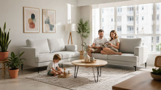 White fabric sofas in a bright Singapore living room with a family relaxing around a practical seating layout