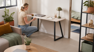 Light marble-look study desk with black metal legs in a compact Singapore home study corner with measuring tools for planning a 2-room Flexi layout.