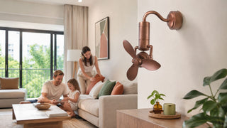 Rose bronze wall-mounted table fan in a bright Singapore condo living room with a family relaxing on a cream sofa