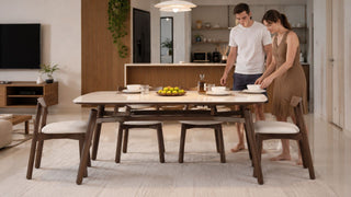 Modern dining table set in a Singapore home with a couple preparing the dining area for daily use.