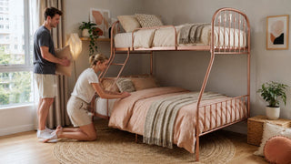 Rose gold toddler bunk bed in a modern Singapore family bedroom with parents arranging soft bedding.