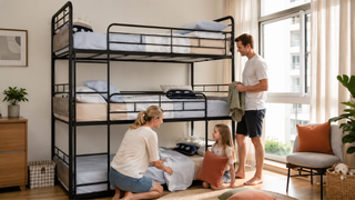 Triple bunk bed in a bright Singapore family bedroom with parents and child arranging bedding.