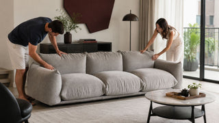Light grey velvet sofa in a modern Singapore living room with a couple tidying cushions for a practical repair or replace sofa decision.