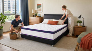 Black upholstered vintage-style bed frame with white mattress in a practical Singapore condo bedroom.