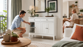 White buffet cabinet with open storage in a modern Singapore apartment living and dining area.