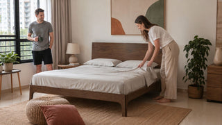 Wooden bed frame with headboard in a modern Singapore bedroom, styled with neutral bedding and practical home decor for MegaFurniture