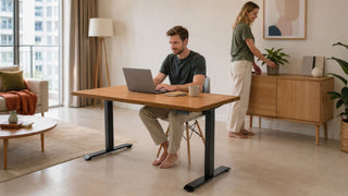 Adjustable writing desk in a modern Singapore apartment home office with a warm wood finish and practical living room layout