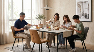 Family seated around a modern kitchen table with cushioned dining chairs in a warm Singapore home