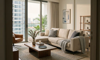 Modern beige sofa in a Singapore condo living room with coffee table, balcony view, and natural light.